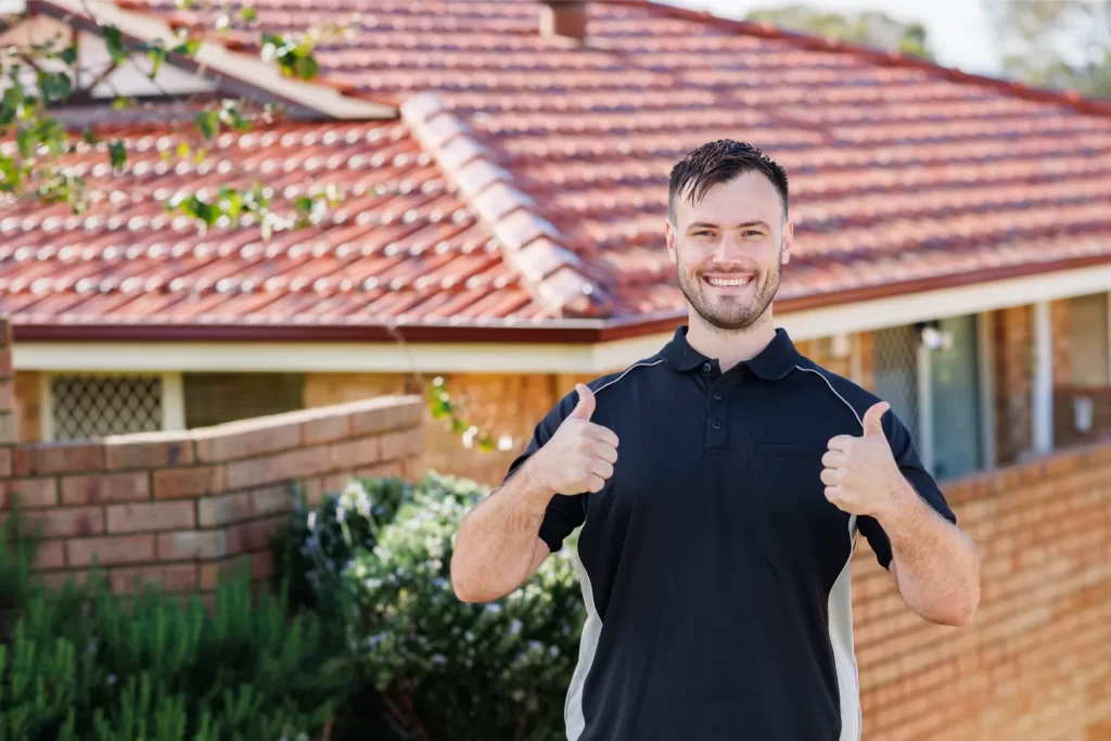 Thumbs up after finishing a roof pressure cleaning job